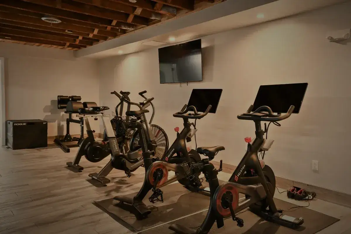 Studio bikes facing wall-mounted screens.