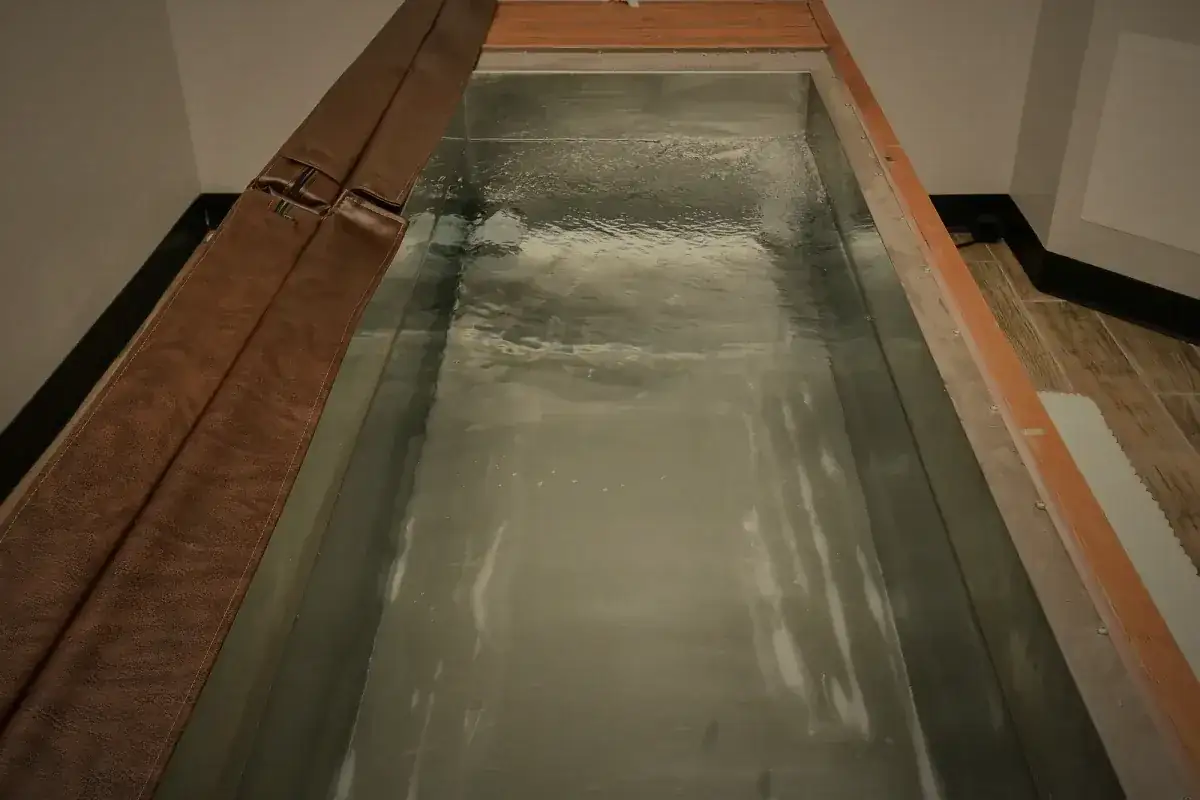 The cold plunge, water in a timber surround.