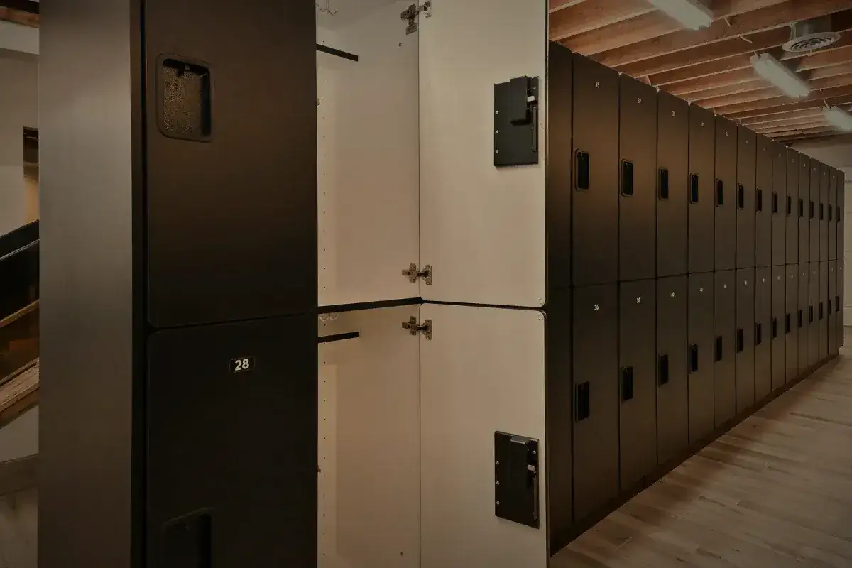 Full height lockers, close, with the bench and the timber ceiling.