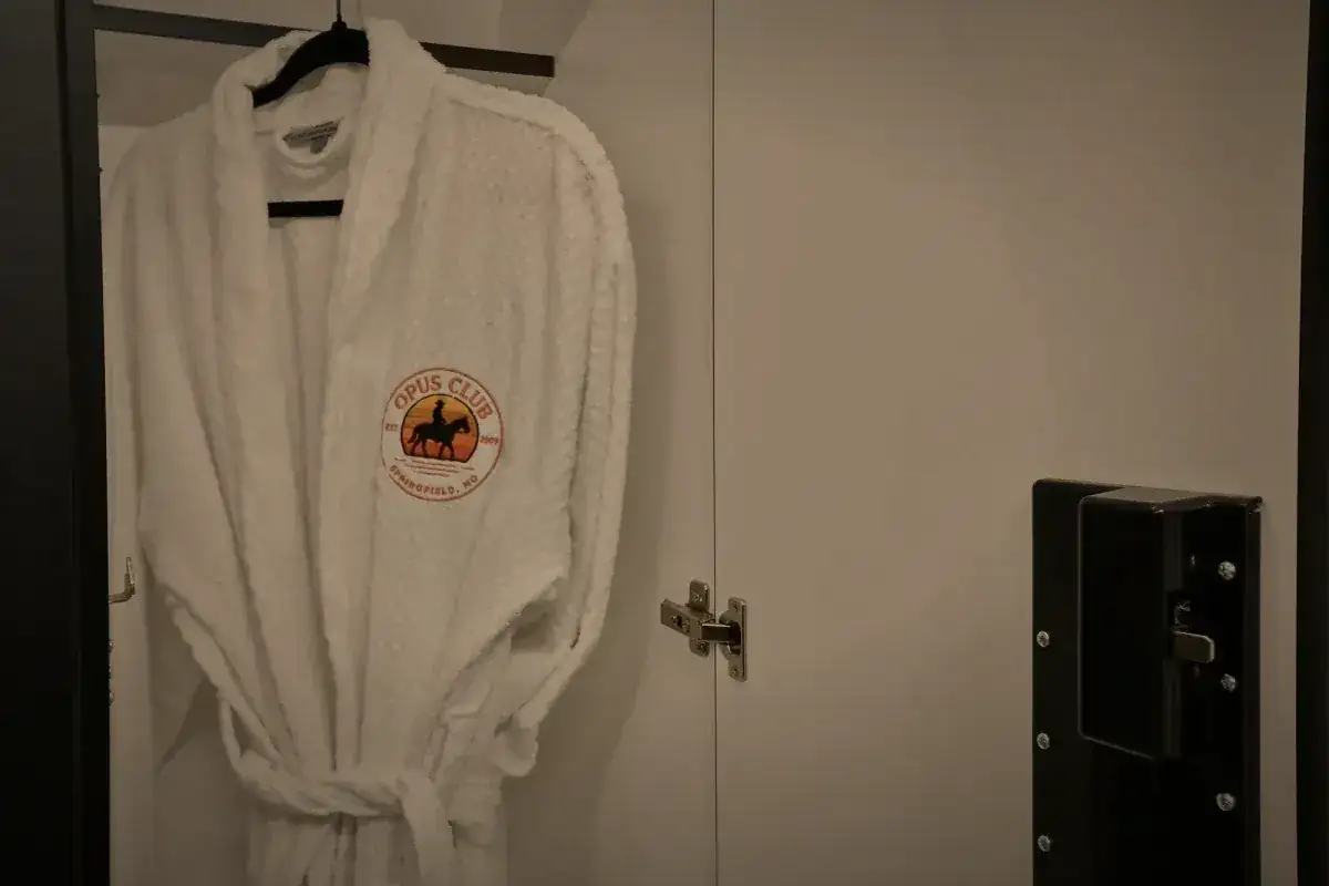 A club robe hanging on the back of a door.